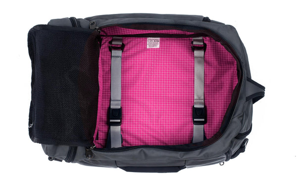 An open Techonaut 30 with a Nebulous Grey (dark grey) exterior and an Cerise (pink) interior.
